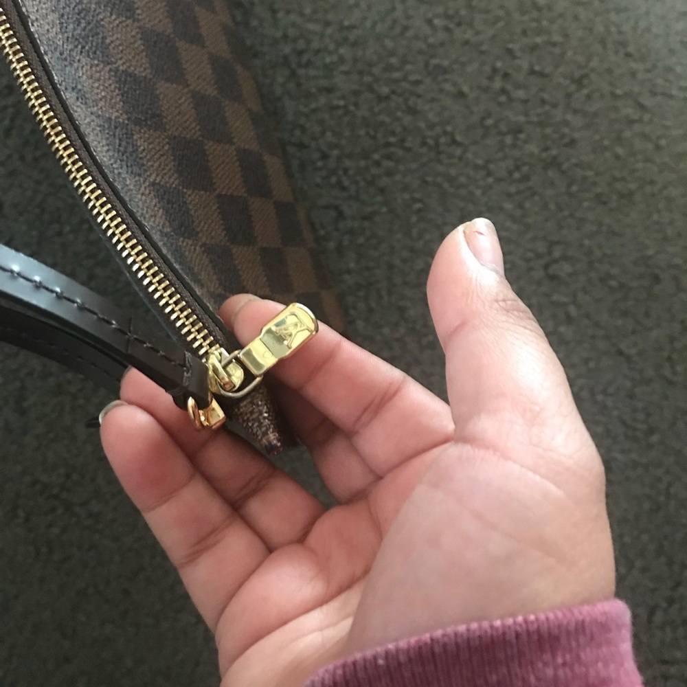 A Louis Vuitton wristlet